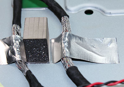 Conductive adhesive tape used to secure cables to metal frames